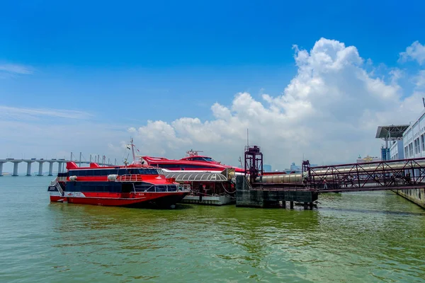 MACAU, CHINA- MAY 11, 2017: Macau Ferry terminal and red turbojet boats in a beautiful blue sky — Stock Photo, Image