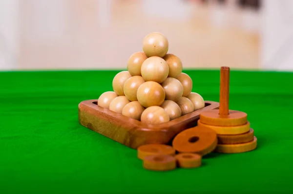 Wooden Brain Teaser or Wooden Puzzles on green floor in blurred background