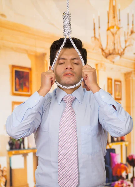 Depressed man with a noose around his neck, back view in a room background — Stock Photo, Image