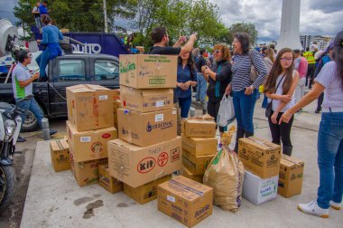 Quito, Ekvator - Nisan, 17, 2016: Afet Yardım gıda, giyim, ilaç ve su kıyılarında deprem kurtulanlar için sağlayan tanımlanamayan vatandaşları Quito. La Caolina Park'ta toplandı