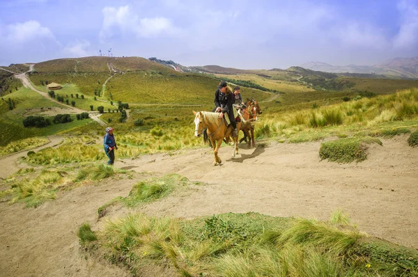 Pichincha, Ecuador September 18, 2017: Tourist riding a horse on the top of the Pichincha mountain with a panoramic view at the Pichincha volcano, located just to the side of Quito, which wraps around — Stock Photo, Image