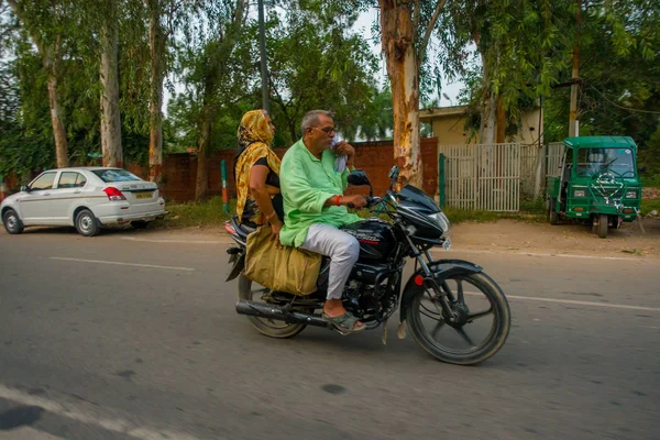 Agra, indien - 19. september 2017: unbekanntes paar fährt mit motorrad auf den straßen in zentralindien in agra, indien — Stockfoto