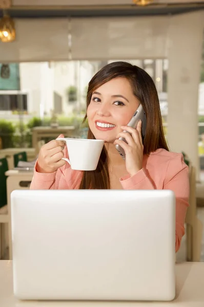 Primo piano di una giovane bella donna d'affari che lavora e beve caffè mentre sta usando il suo cellulare per fare una chiamata. Concetto aziendale — Foto Stock