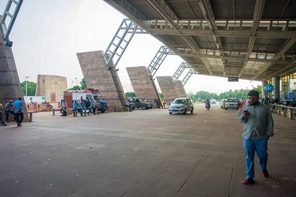 Delhi, indien - 19. september 2017: Unbekannte gehen vor dem internationalen flughafen von delhi spazieren, wo einige autos auf touristen warten. indira gandhi internationaler flughafen ist der — Stockfoto