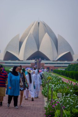 Delhi, India - September 27, 2017: Unidentified people enjoying the beautiful Lotus Temple, located in New Delhi, India, is a Bahai House of Worship clipart