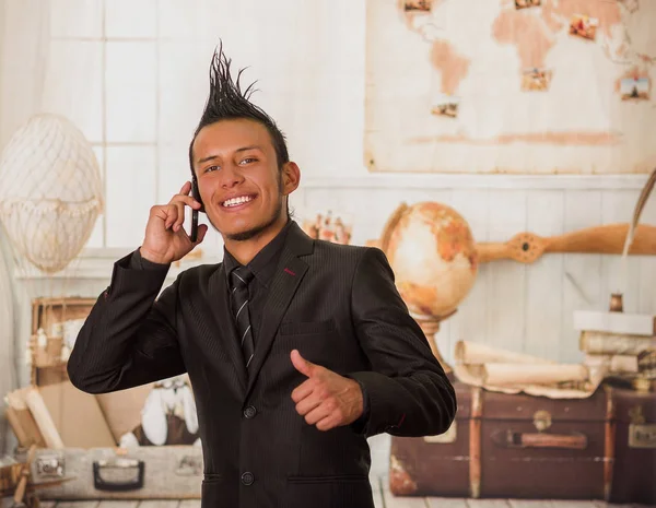 Nahaufnahme eines glücklichen Büropunks im Anzug mit Wappen, der sein Handy im Büro vor verschwommenem Hintergrund benutzt — Stockfoto