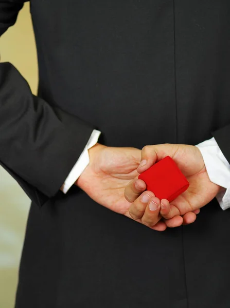 Close up shot of man holding ring box Stock Picture