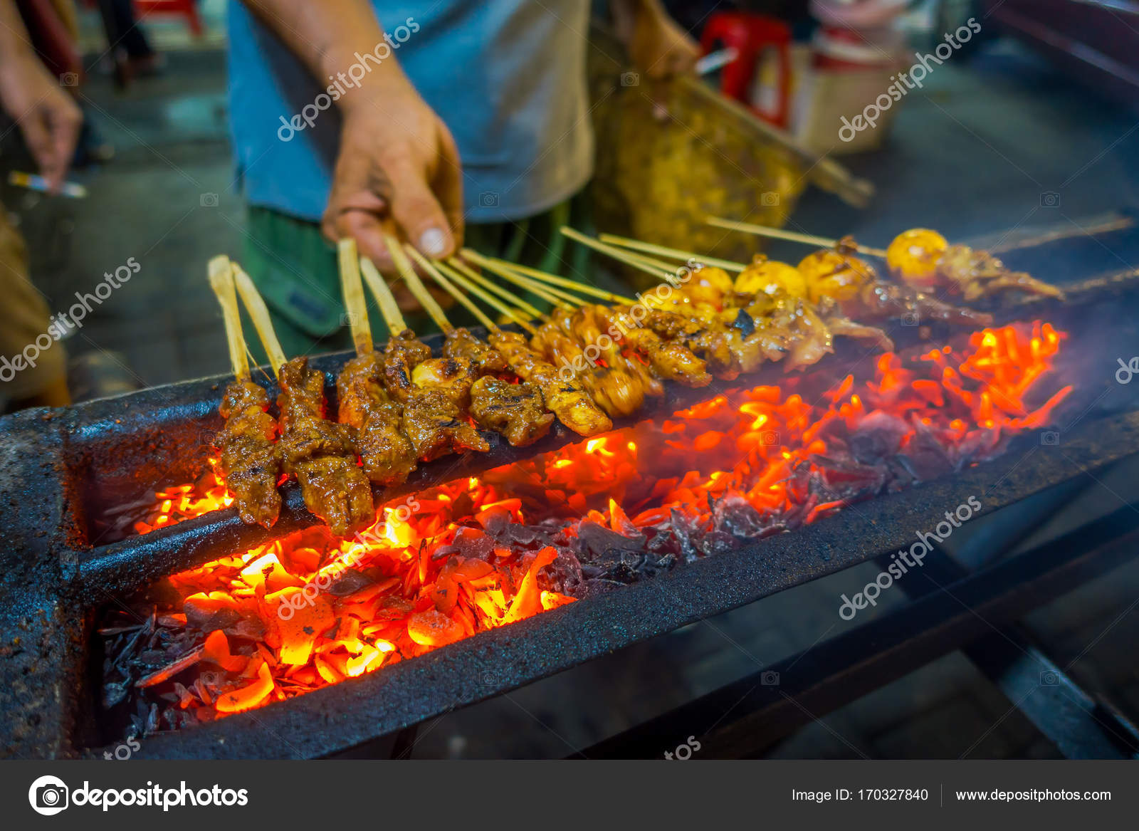 JAKARTA, INDONESIA Street barbecue with meat skewers sizzling, very