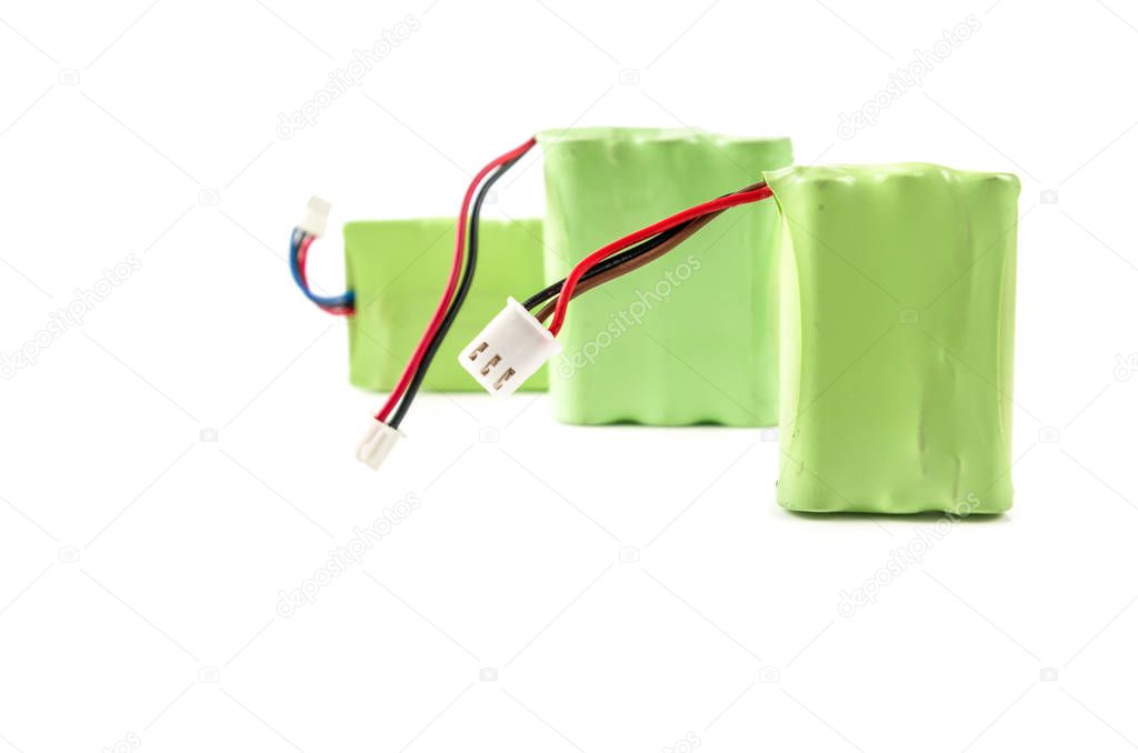 Close up of a battery covered with a green plastic isolated on white background