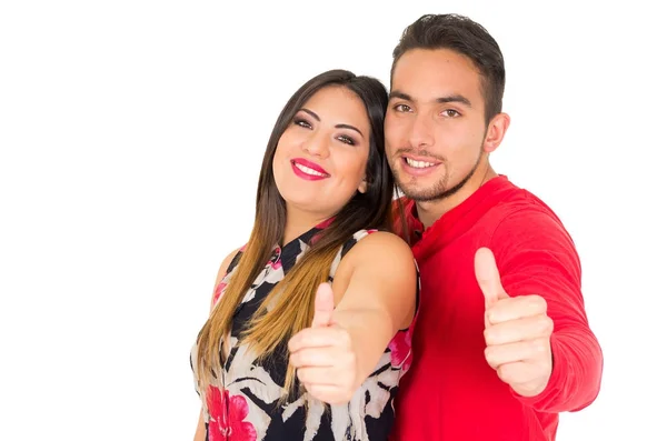 Happy couple embracing and looking camera, with thumbs up, on white background — Stock Photo, Image