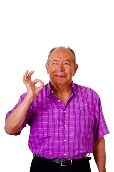 Портрет счастливого старика, делающего успешный знак рукой и носящего фиолетовую квадратную футболку на белом фоне — стоковое фото