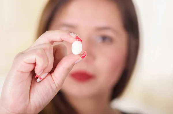 Portrait of a young woman holding in her hand a soft gelatin vaginal tablet or suppository, treatment of diseases of the reproductive organs of women and prevention of womens health — Stock Image Portrait of a young woman holding in her hand a soft gelatin vaginal tablet or suppository, treatment of diseases of the reproductive organs of women and prevention of womens health Stock Picture
