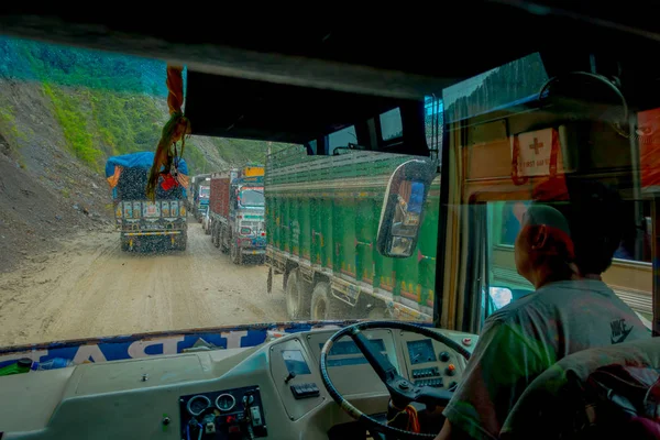 POKHARA, NEPAL OCTOBER 10, 2017: Close up of a bus driver from the cabain driving a truck on the road in the streets, located in Pokhara, Nepal — Stock Photo, Image