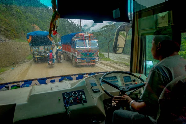 POKHARA, NEPAL OCTOBER 10, 2017: Close up of a bus driver from the cabain driving a truck on the road in the streets, located in Pokhara, Nepal — Stock Photo, Image