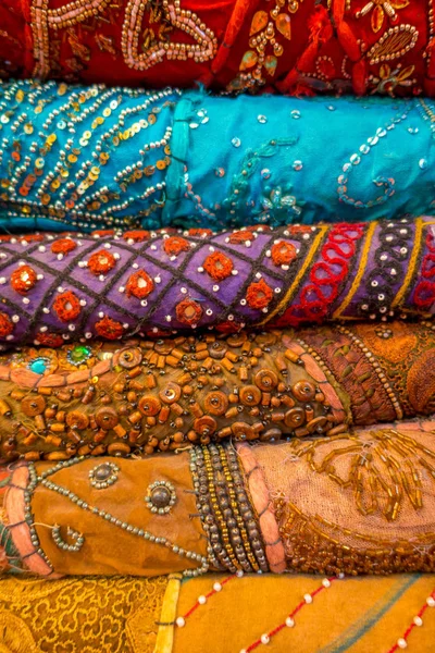 Close up of heap of cloth fabrics at a local market in India, vertical view — Stock Photo, Image