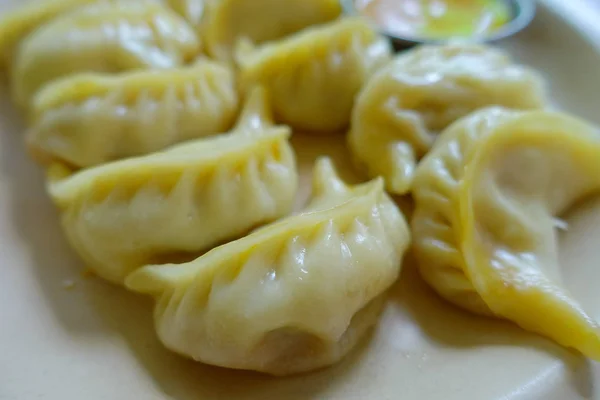 Close up de Momo cozido no vapor servido em um prato branco. Um alimento nepalês popular que também é comum em Chiana, Butão, Tibete e Índia — Fotografia de Stock