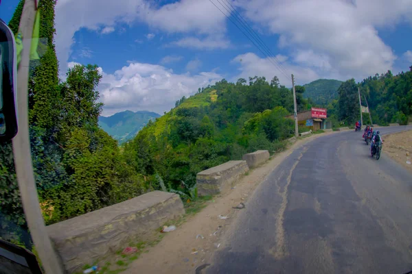 POKHARA, NEPAL OCTOBER 10, 2017: Beautiful view of asphelevroad with some motorbikes around in the street, located in Pokhara, Nepal — стоковое фото