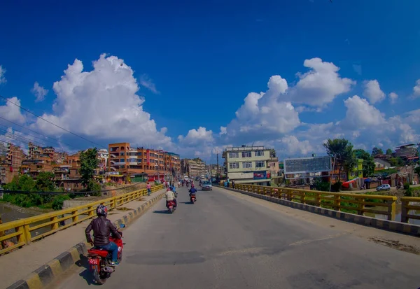 NAGARKOT, NEPAL OCTOBER 11, 2017: Close up of some people riding their motorbikes around the city in Nagarkot Nepal, fish eye effect — Stock Photo, Image
