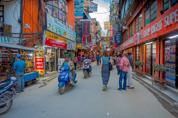 KATHMANDU, NEPAL OCTOBER 15, 2017: Unidentified people walking in a busy shopping street with colorful decorations in Thamel district of Kathmandu, Nepal