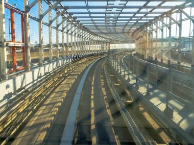 Tokyo, Japonya Haziran 28-2017: mavi açık güneşli gökyüzü altında Odaiba, Minato, Tokyo Yurikamome satırının yükseltilmiş demiryolu seyahat eden bir tren toplayan