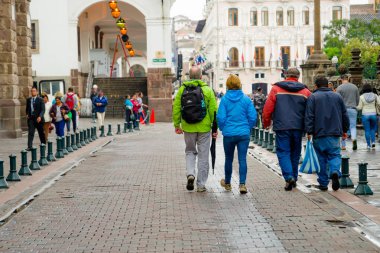 QUITO, ECUADOR NOVEMBER, 28, 2017: Unidentified people walking at historical center of old town Quito in northern Ecuador in the Andes mountains, Quito is the second highest capital city in the world clipart