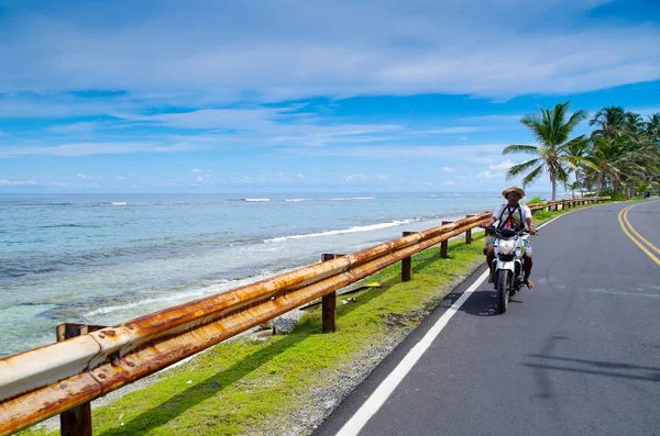 San Andres, Colombia - 21 oktober 2017: Onbekende man rijden op zijn motorfiets in een weg in San Andres, Colombia in een prachtige beach-achtergrond — Stockfoto