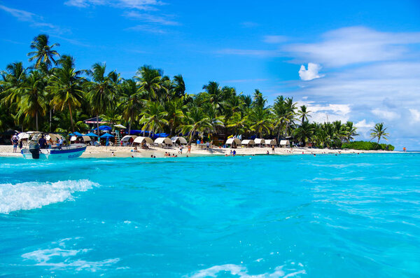 SAN ANDRES, COLOMBIA - OCTOBER 21, 2017: Unidentified people enjoying the beautiful sunny day and swimming in the turquoise water in the coast of San Andres