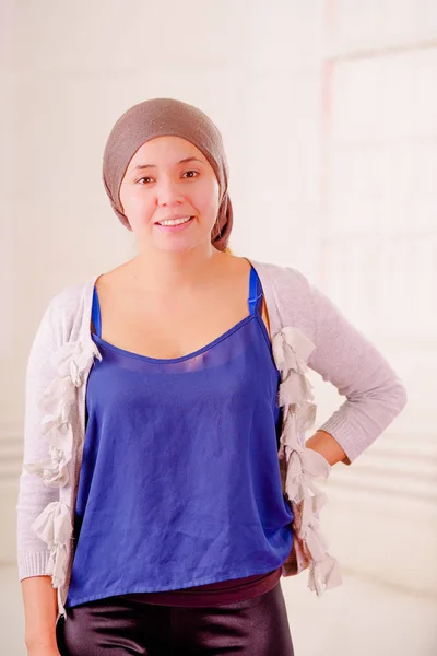 Close up of a woman with cancer wearing headscarf, having positive attitude, in a blurred background — Stock Photo, Image