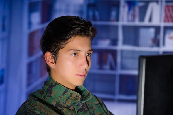 Portrait of handsome young soldier wearing a military uniform, military drone operator watching at his computer — Stock Photo, Image