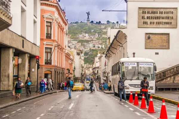 QUITO, ECUADOR NOVEMBER, 28, 2017: Close up of orange cones in the historical center, with some people walking in the streets near of a bus, public transport bus, of old town Quito in northern Ecuador — Stock Photo, Image