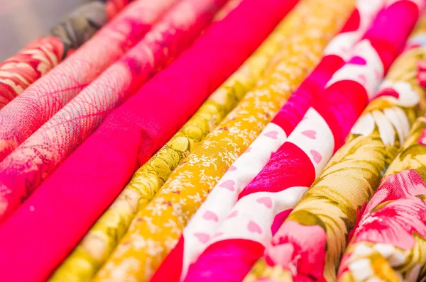 Close up of different fabric of different colors, fabric waiting for sewing clothes and other things, red, yellow fabric — Stock Photo, Image