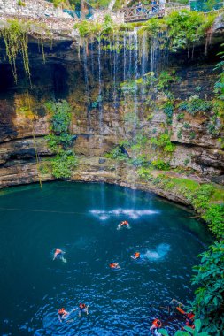 Chichen Itza, Meksika - 12 Kasım 2017: kimliği belirsiz kişi IK-Kil hipotermik Chichen Itza, Meksika yakınındaki yüzme. Duru suları ve asılı kökleri ile güzel hipotermik