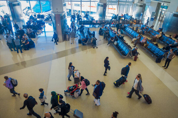 LOS ANGELES, EEUU, JANUARY, 29, 2018: Above view of unidentified people sitting in the chairs waiting inside of the airport for departure flights, of the Los Angeles International Airport LAX , the