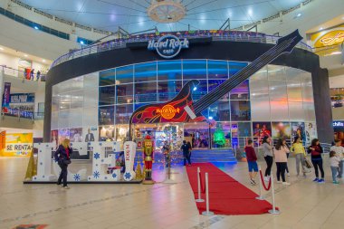 CANCUN, MEXICO - JANUARY 22, 2015: Beautiful indoor view of unidentified people walking inside of The Forum in the Cancun hotel zone is a popular place for tourists to enjoy modern shopping