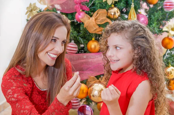 Close up of smiling family decorating Christmas tree, mom and daughter, family christmas concept — Stock Photo, Image