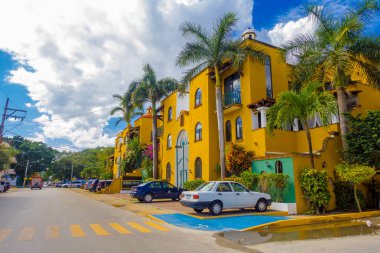 Playa del Carmen, Mexico - January 10, 2018: Outdoor view of cars parked in a huge and beautiful house in Playa del Carmen in the Riviera Maya clipart