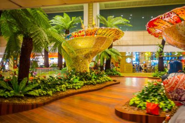 Singapur - yaklaşık Ağustos, 2016: Singapur Changi Havaalanı içinde bitkiler ile küçük bir bahçede yürüyüş insanlar kapalı görünümünü. Singapur Changi Havaalanı Singapore için birincil sivil Havaalanı olduğunu
