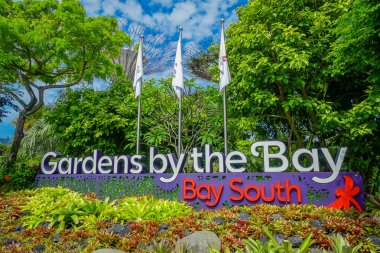 SINGAPORE, SINGAPORE - JANUARY 30, 2018: Informative sign in day view of Entrance to Gardens by the Bay in Singapore. Spanning 101 hectares, and five-minute walk from Bayfront MRT Station clipart