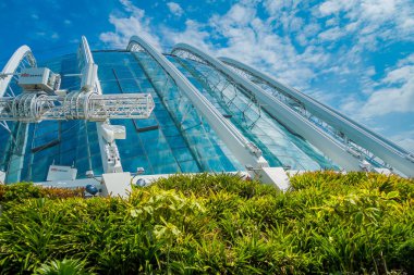 SINGAPORE, SINGAPORE - JANUARY 30, 2018: Outdoor view of Cloud Forest Flower Dome at Gardens by the Bay in Singapore. Spanning 101 hectares of reclaimed land in central Singapore, adjacent to Marina clipart