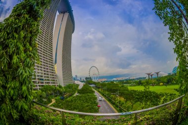 SINGAPORE, SINGAPORE - JANUARY 30, 2018: Beautiful landscape of two towers of the Marina Bay Sands Ressort against a cloudy sky, the worlds most expensive standalone casino at the time of opening in clipart