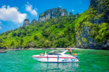 AO NANG, THAILAND - MARCH 05, 2018: Unidentified tourists in a yatch enjoying a gorgeous turquoise water in the chicken island in Thailand clipart