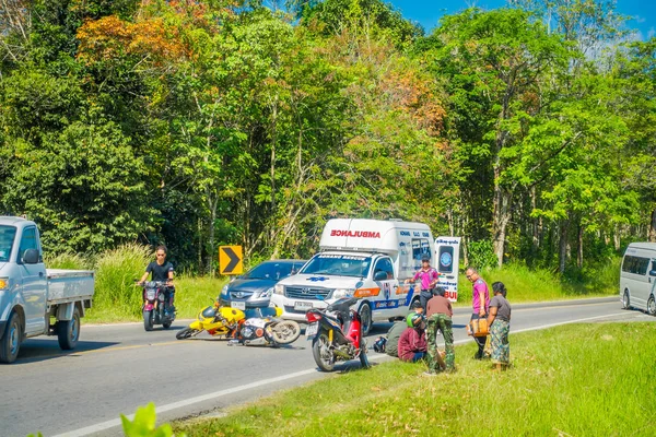 AO NANG, THAILAND - FEBRUARY 09, 2018: Outdoor view of motorcycles accident in the road with an ambulance parked at one side giving the first aids at Ao Nang beach front market — Stock Photo, Image