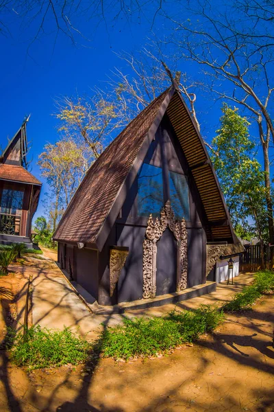 Outdoor view of many houses in Baan Dam museum, the Black House in Chiang Rai Thailand — Stock Photo, Image