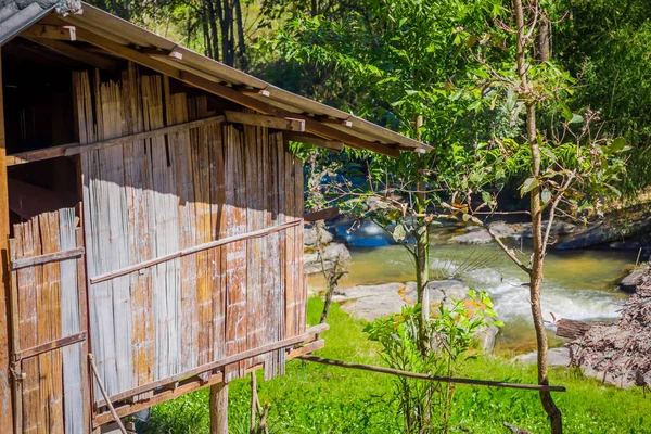 Outdoor view of a gorgeous house building with bamboo cane in tropical rainforest with a river behind in Chiang Mai Province, Thailand — Stock Photo, Image