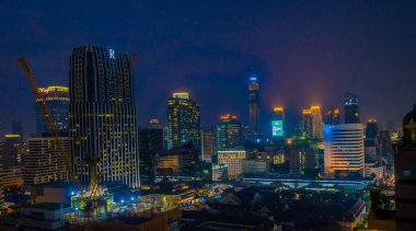 Beautiful panorama view of nightlife of Bangkok city and buildings clipart