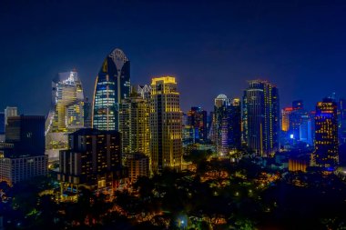 Bangkok gece şehir manzarası. Panoramik ve perspektif görünüm açık altın renkli cam yüksek artış gelecek gökdelen ticari bina. İş kavramı başarı endüstri teknik mimari