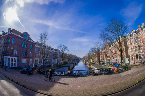 АМСТЕРДАМ, НИДЕРЛАНДЫ, МАРТ, 10 МАРТА 2018: Великолепный вид снаружи на людей, прогуливающихся вблизи каналов Амстердама, является столицей и самым густонаселенным городом Нидерландов — стоковое фото