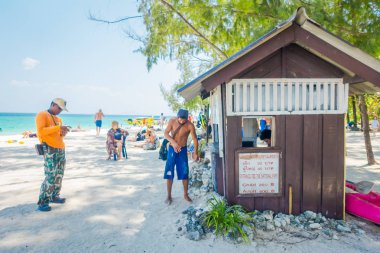 PODA, THAILAND - FEBRUARY 09, 2018: Outdoor view of unidentified people close to a hut of payment fee to enter the phi phi national park on Poda island