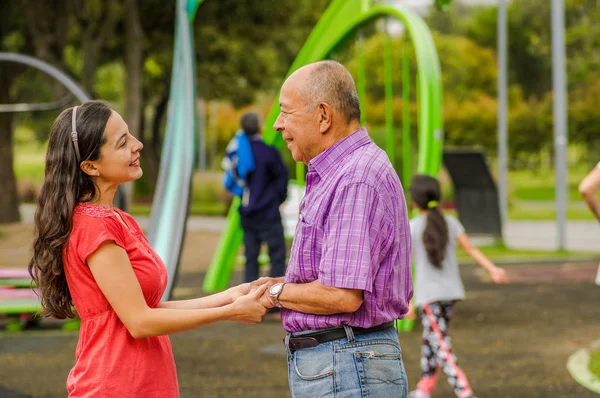Outdoor view of daughter and father holding their hands at outdoors in the park — Stock Photo, Image