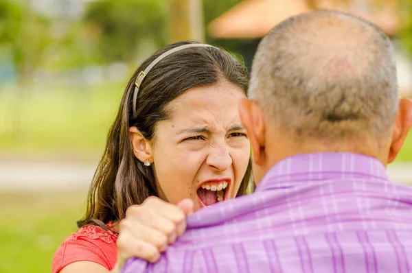 Close up of daughter arguing with his father at outdoors — Stock Photo, Image